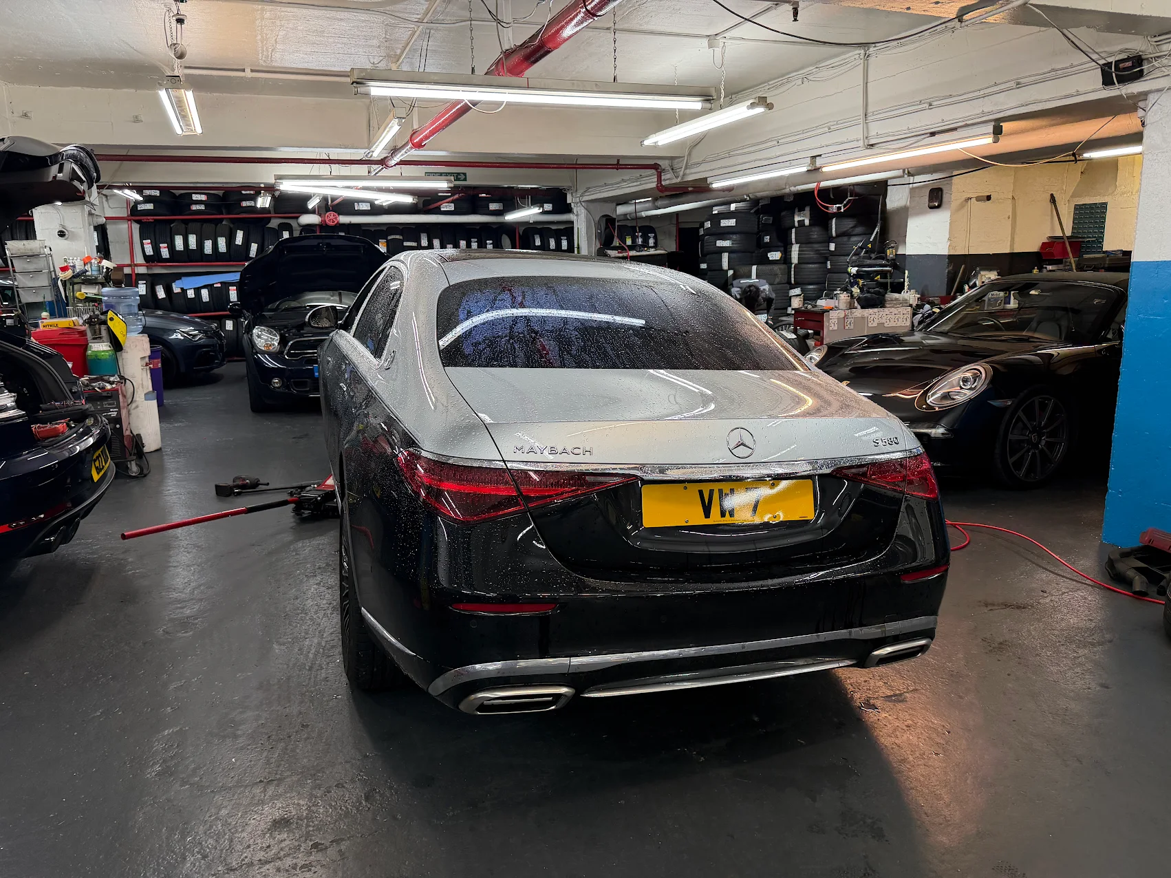 Mercedes-Maybach in the One Way Motors workshop with tyre wall and lifts behind