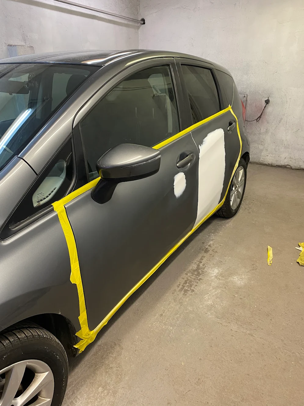 Door panel prep — bodywork repair underway on a Nissan