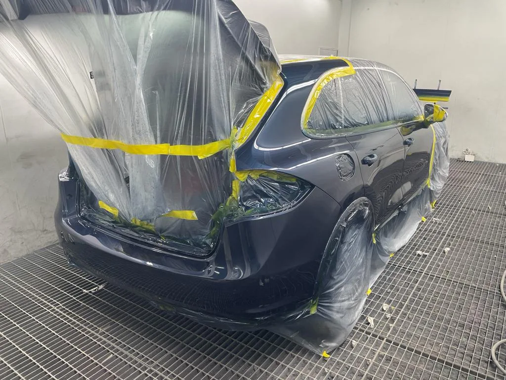 Porsche Cayenne masked up in our paint booth, ready for refinishing